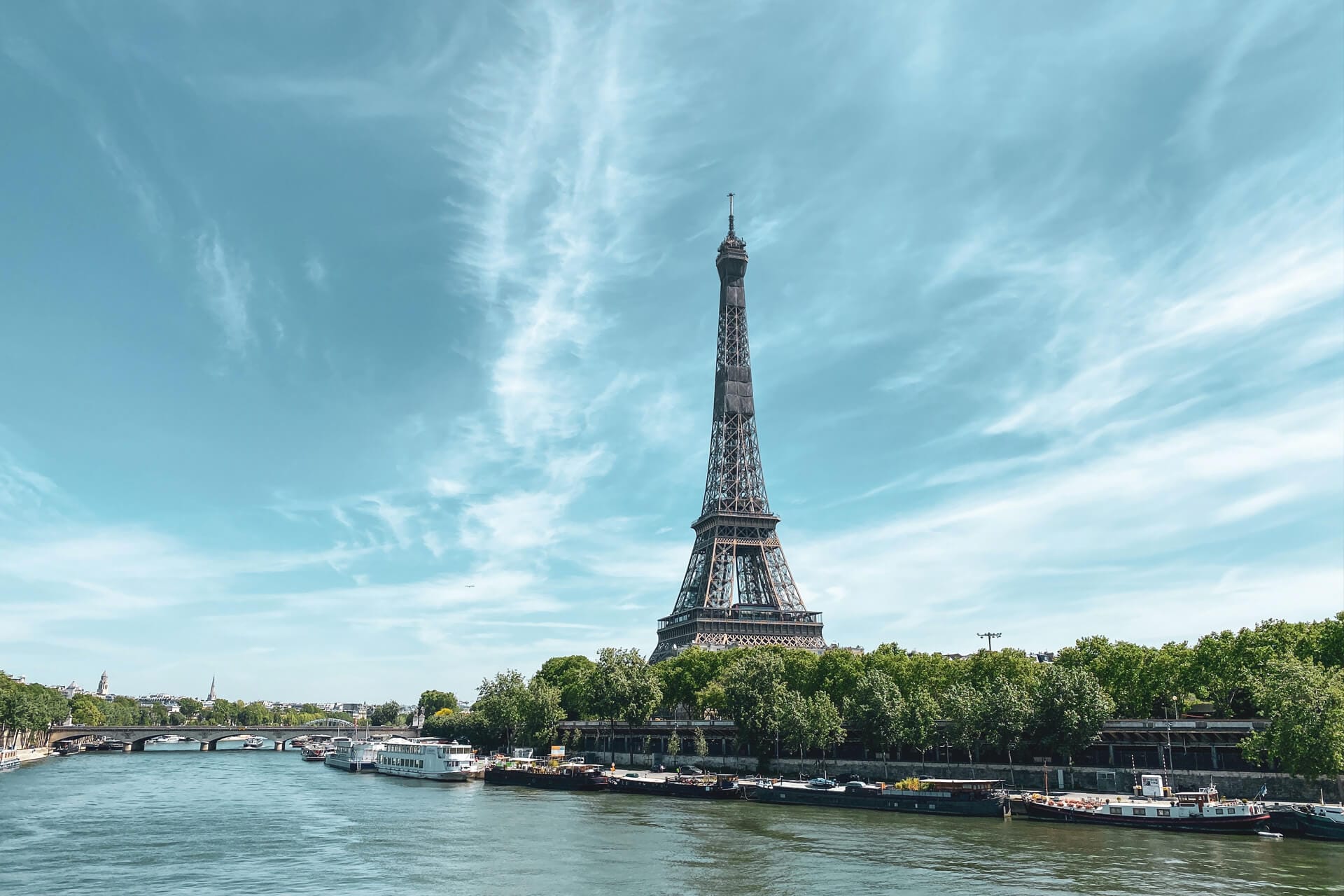 Eiffel Tower and Seine river boats in Paris